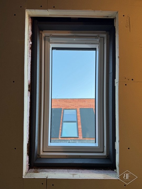 New roof window installed in a framed opening, seen from inside