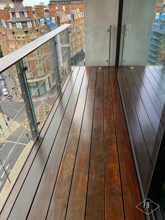 Balcony hardwood deck with glass balustrade overlooking a London street