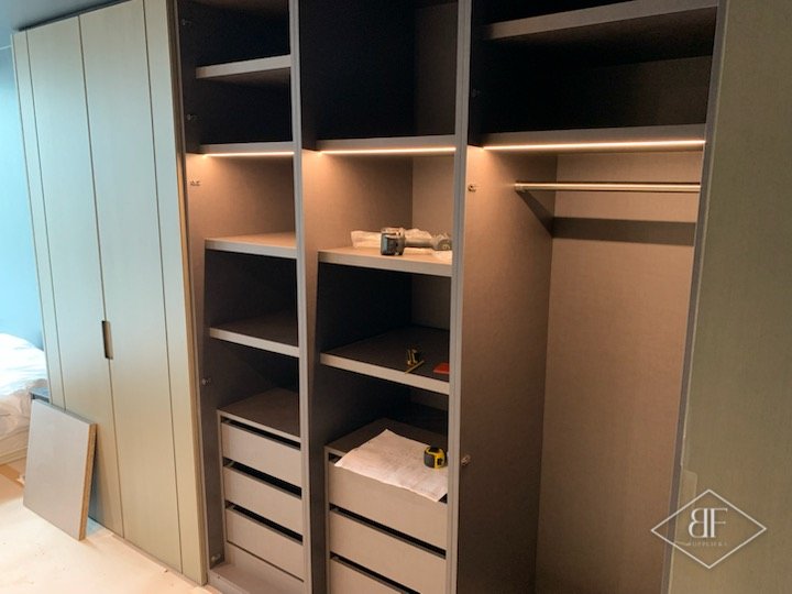 Wardrobe interior with hanging rail, shelves, internal drawers and integrated lighting