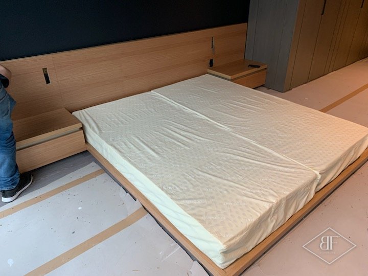 Mattress laid on the finished bespoke platform bed with integrated bedside units