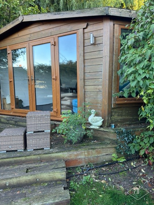 Garden room with old timber steps and decking, seen before the works