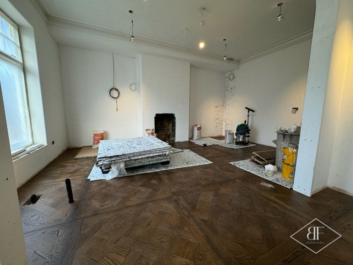 Spacious room with new parquet flooring in Chelsea while other work continues