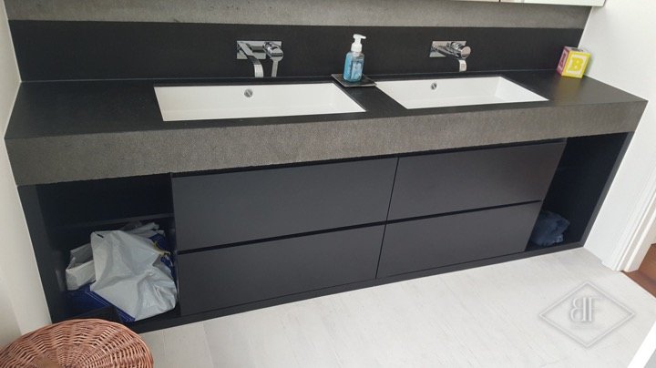 Dark vanity unit with large double basins and stone-effect worktop