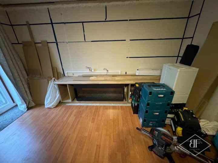 Before: bare wall and floor in Walthamstow living room ready for the media wall