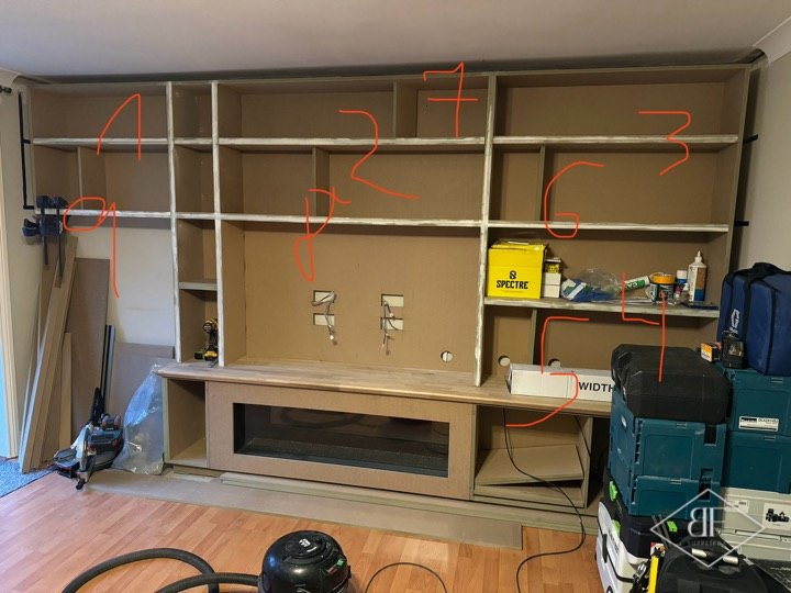 Media wall carcass assembled with open shelf bays and fire opening before painting