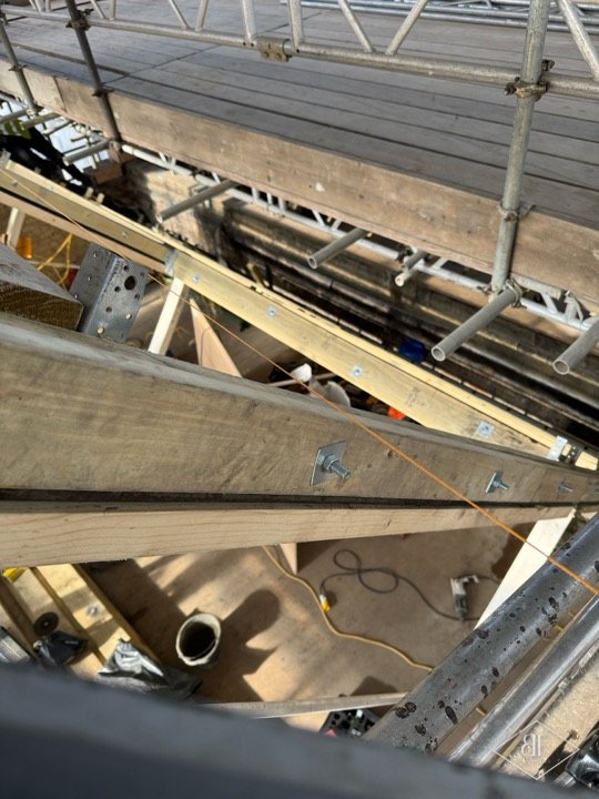Close view of new timber purlin and rafter connections inside the roof space