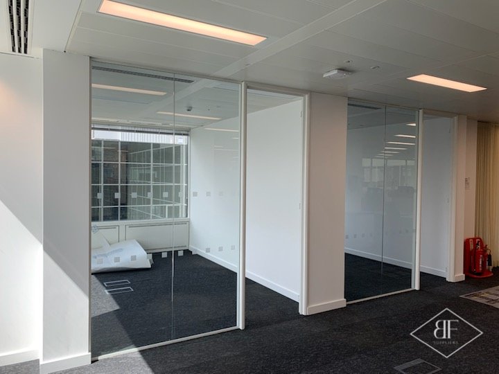 Two glazed partition sections with frosted manifestation dots along the office floor