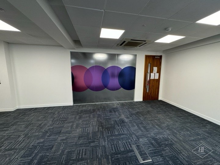 Meeting room fitted with printed glass partition and walnut door