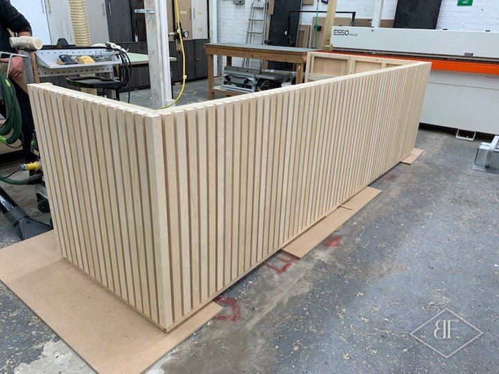 Slatted desk assembled in the workshop on protective board before delivery