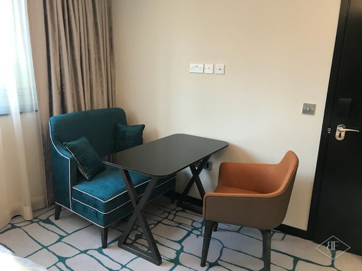 Seating corner with armchairs and a small dark table in a showroom suite