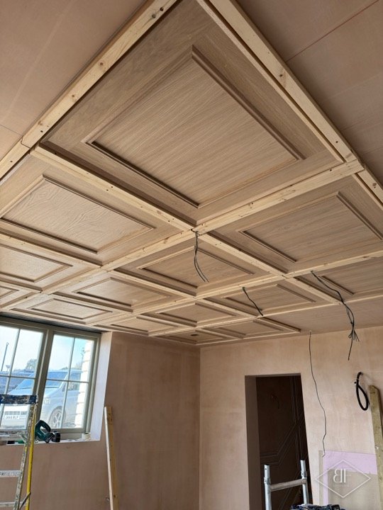 Coffered oak ceiling during installation in Tunbridge Wells with wiring still visible