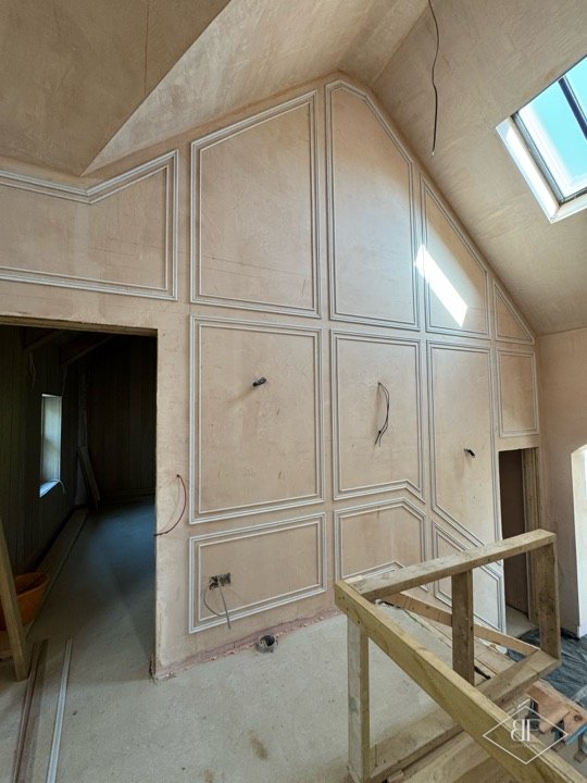Panelled wall and vaulted ceiling with rooflight at stairwell landing, mid-build